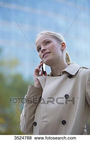 Portrait of a business woman with mobile in front of an office building View Large Photo Image Stock Photo - Portrait of a business woman with mobile in front of an office building. Fotosearch