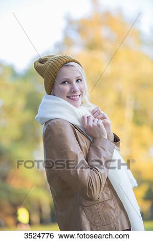 Portrait of a content pretty blonde woman with bonnet and scarf in Autumn View Large Photo Image Stock Photograph - Portrait of a content pretty blonde woman with bonnet and scarf in Autumn. Fotosearch