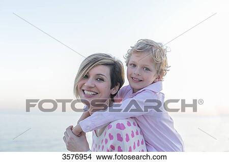 Portrait of a cute little boy with mum smiling at camera View Large Photo Image Picture - Portrait of a cute little boy with mum smiling at camera. Fotosearch