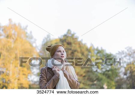 Portrait of a daydreaming woman in park in autumn View Large Photo Image Picture - Portrait of a daydreaming woman in park in autumn. Fotosearch