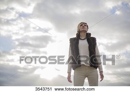 Stock Image - Portrait of a elegant and pretty woman looking at horizon. Fotosearch