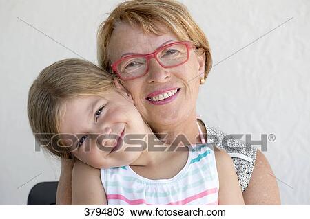 Portrait of a little girl in the lap of her grandmother. View Large Photo Image Stock Image - Portrait of a little girl in the lap of her grandmother.. Fotosearch