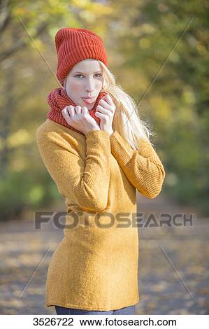Portrait of a playful blonde woman in park in autumn View Large Photo Image Stock Image - Portrait of a playful blonde woman in park in autumn. Fotosearch