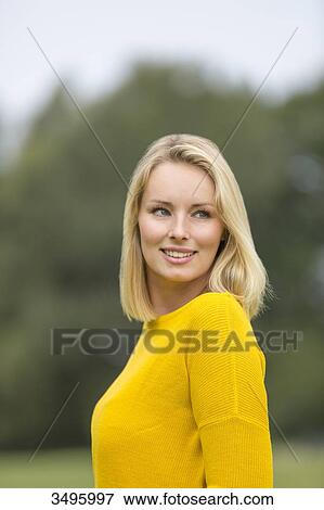 Portrait of a pretty blond woman in the park smiling at camera View Large Photo Image Stock Photo - Portrait of a pretty blond woman in the park smiling at camera. Fotosearch