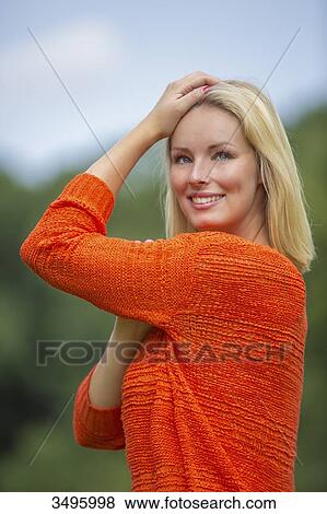 Portrait of a pretty blond woman in the park smiling at camera View Large Photo Image Stock Photo - Portrait of a pretty blond woman in the park smiling at camera. Fotosearch
