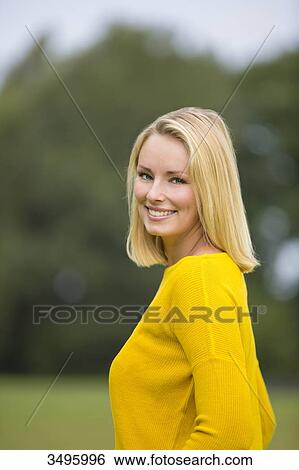 Portrait of a pretty blond woman in the park smiling at camera View Large Photo Image Stock Photograph - Portrait of a pretty blond woman in the park smiling at camera. Fotosearch