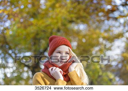 Portrait of a pretty blonde woman in park in autumn View Large Photo Image Picture - Portrait of a pretty blonde woman in park in autumn. Fotosearch
