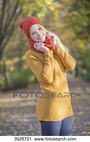 Portrait of a pretty blonde woman in park in autumn smiling at camera View Large Photo Image Stock Image - Portrait of a pretty blonde woman in park in autumn smiling at camera. Fotosearch
