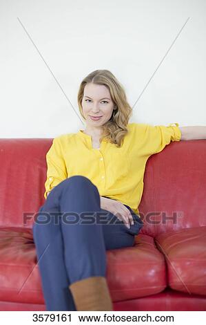 Portrait of a pretty blonde woman on the couch looking at camera View Large Photo Image Stock Image - Portrait of a pretty blonde woman on the couch looking at camera. Fotosearch