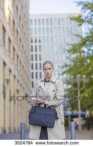 Portrait of a pretty blonde woman stressed watching the time View Large Photo Image Picture - Portrait of a pretty blonde woman stressed watching the time. Fotosearch