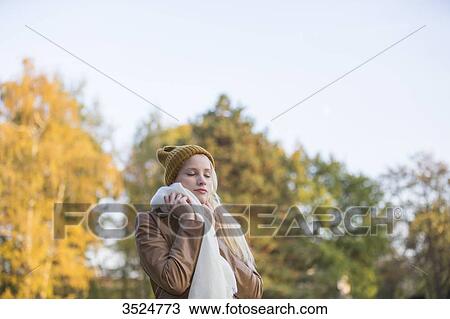 Portrait of a pretty blonde woman with bonnet and scarf in Autumn with eyes closed View Large Photo Image Stock Image - Portrait of a pretty blonde woman with bonnet and scarf in Autumn with eyes closed. Fotosearch