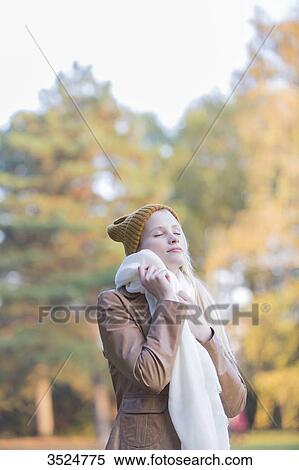 Portrait of a pretty blonde woman with bonnet and scarf in Autumn with eyes closed View Large Photo Image Stock Photography - Portrait of a pretty blonde woman with bonnet and scarf in Autumn with eyes closed. Fotosearch