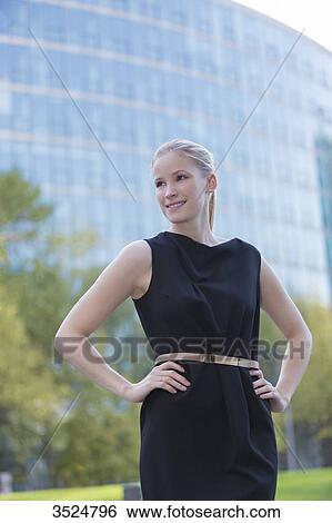 Stock Photograph - Portrait of a pretty elegant woman in front of an office building. Fotosearch