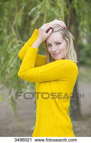 Portrait of a sensual blonde woman in park looking at camera View Large Photo Image Stock Image - Portrait of a sensual blonde woman in park looking at camera. Fotosearch