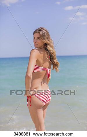 Portrait of a sexy blonde woman in bikini at the beach seducing camera View Large Photo Image Stock Image - Portrait of a sexy blonde woman in bikini at the beach seducing camera. Fotosearch