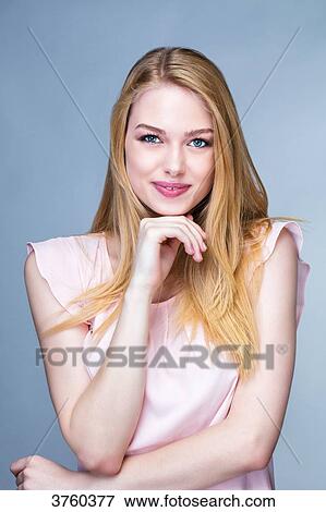 Portrait of a smiling young woman, one hand under the chin View Large Photo Image Stock Photo - Portrait of a smiling young woman, one hand under the chin. Fotosearch