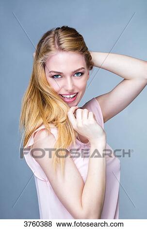 Portrait of a smiling young woman, one arm behind his head View Large Photo Image Stock Photo - Portrait of a smiling young woman, one arm behind his head. Fotosearch