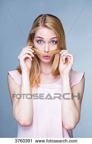 Portrait of a young astonished woman, hair in front of the mouth View Large Photo Image Stock Image - Portrait of a young astonished woman, hair in front of the mouth. Fotosearch