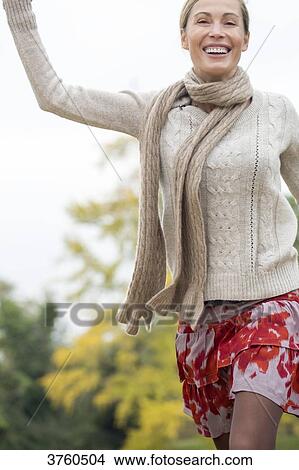 Portrait of a young blonde woman smilling and dynamic in a wood in autumn. View Large Photo Image Picture - Portrait of a young blonde woman smilling and dynamic in a wood in autumn.. Fotosearch