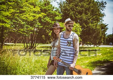Portrait of a young couple Hipster ride in the countryside, a guitar in hand View Large Photo Image Stock Photography - Portrait of a young couple Hipster ride in the countryside, a guitar in hand. Fotosearch