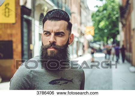 Portrait of a young hipster in an urban environment View Large Photo Image Stock Photograph - Portrait of a young hipster in an urban environment. Fotosearch