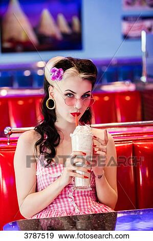 Portrait of a young Pin Up, enjoying his milkshake View Large Photo Image Stock Photo - Portrait of a young Pin Up, enjoying his milkshake. Fotosearch