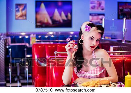 Portrait of a young Pin Up, face in profile, holding a small American flag View Large Photo Image Stock Image - Portrait of a young Pin Up, face in profile, holding a small American flag. Fotosearch