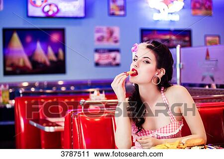 Portrait of a young Pin Up, face in profile, putting a fry in his mouth View Large Photo Image Stock Image - Portrait of a young Pin Up, face in profile, putting a fry in his mouth. Fotosearch