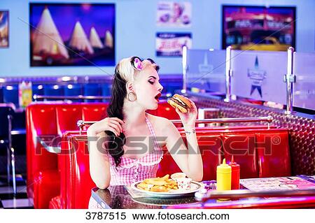 Portrait of a young Pin Up, face in profile, eats his hamburger View Large Photo Image Stock Photography - Portrait of a young Pin Up, face in profile, eats his hamburger. Fotosearch