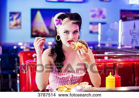 Portrait of a young Pin Up, Front, eating his hamburger View Large Photo Image Picture - Portrait of a young Pin Up, Front, eating his hamburger. Fotosearch