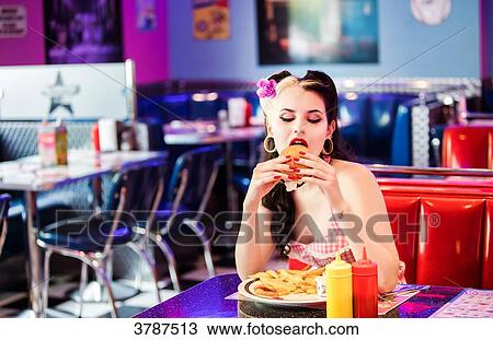 Portrait of a young Pin Up, Front, eating his hamburger View Large Photo Image Stock Image - Portrait of a young Pin Up, Front, eating his hamburger. Fotosearch