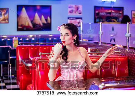 Portrait of a young Pin Up, happily enjoying his milkshake View Large Photo Image Stock Photo - Portrait of a young Pin Up, happily enjoying his milkshake. Fotosearch
