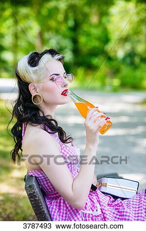 Portrait of a young Pin Up profile drinking a soda View Large Photo Image Stock Image - Portrait of a young Pin Up profile drinking a soda. Fotosearch