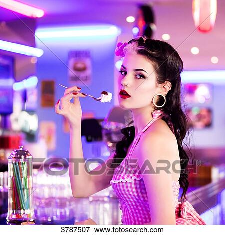 Portrait of a young Pin Up profile, delicately holding a spoon whipped View Large Photo Image Stock Photo - Portrait of a young Pin Up profile, delicately holding a spoon whipped. Fotosearch