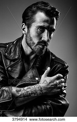 Portrait of a young tattooed man in profile, wearing a leather jacket Perfecto under gray background View Large Photo Image Picture - Portrait of a young tattooed man in profile, wearing a leather jacket Perfecto under gray background. Fotosearch