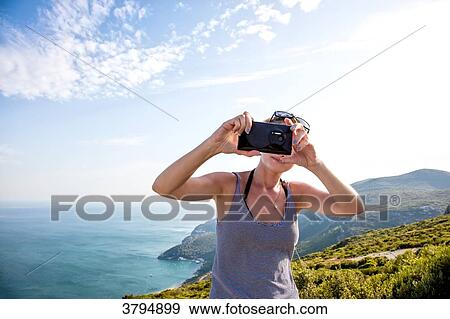 Portrait of a young woman face, taking a selfie with smartphone on the heights of Setubal, Lisbon area, Portugal View Large Photo Image Stock Photo - Portrait of a young woman face, taking a selfie with smartphone on the heights of Setubal, Lisbon area, Portugal. Fotosearch