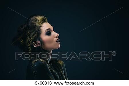 Portrait of a young woman in profile, the body painted black and gold, the look on the side View Large Photo Image Stock Image - Portrait of a young woman in profile, the body painted black and gold, the look on the side. Fotosearch
