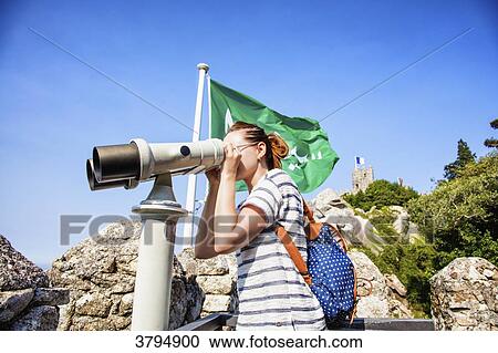 Portrait of a young woman in profile, looking at the Binocular Telescope on the walls of the Moorish castle, Sintra, Lisbon area, Portugal View Large Photo Image Stock Image - Portrait of a young woman in profile, looking at the Binocular Telescope on the walls of the Moorish castle, Sintra, Lisbon area, Portugal. Fotosearch