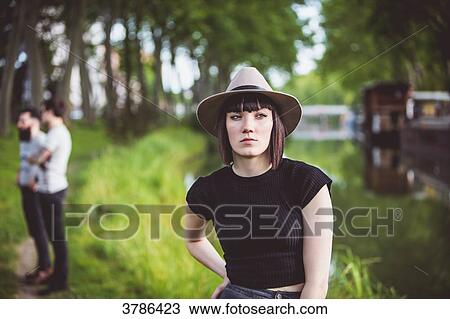 Portrait of a young woman on the banks of the Garonne, bargescand two men in the background View Large Photo Image Stock Image - Portrait of a young woman on the banks of the Garonne, bargescand two men in the background. Fotosearch
