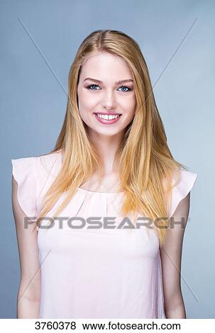 Portrait of a young woman smiling View Large Photo Image Stock Photo - Portrait of a young woman smiling. Fotosearch
