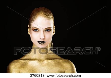 Portrait of a young woman, the body painted gold eyes open View Large Photo Image Stock Photo - Portrait of a young woman, the body painted gold eyes open. Fotosearch