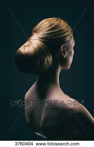 Portrait of a young woman wearing a bun, back View Large Photo Image Picture - Portrait of a young woman wearing a bun, back. Fotosearch