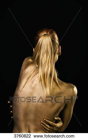 Portrait of a young woman's body painted in gold, back, hands on odds View Large Photo Image Stock Image - Portrait of a young woman's body painted in gold, back, hands on odds. Fotosearch