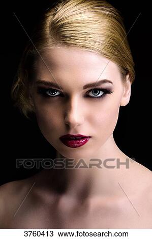 Stock Image - Portrait of an elegant young woman wearing a chignon. Fotosearch