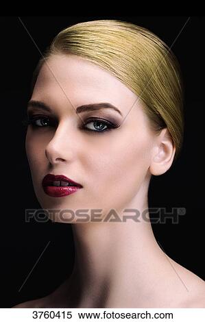 Stock Photography - Portrait of an elegant young woman wearing a chignon. Fotosearch