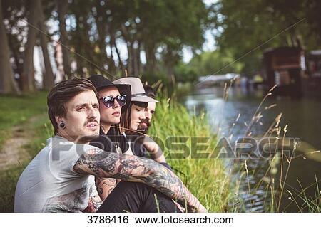 Portraits of young hipster on the banks of the Garonne, barges in the background View Large Photo Image Stock Photograph - Portraits of young hipster on the banks of the Garonne, barges in the background. Fotosearch