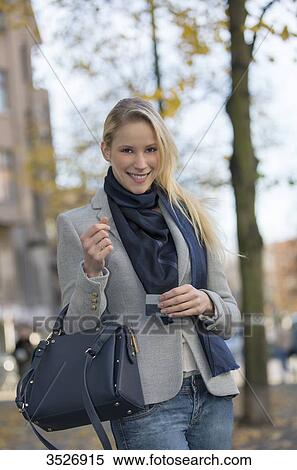 Pretty blond woman shopping and showing bank card in city center View Large Photo Image Stock Photography - Pretty blond woman shopping and showing bank card in city center. Fotosearch