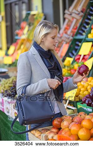 Pretty blonde woman buying healthy food on the market View Large Photo Image Picture - Pretty blonde woman buying healthy food on the market. Fotosearch