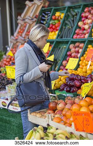Pretty blonde woman buying healthy food on the market View Large Photo Image Picture - Pretty blonde woman buying healthy food on the market. Fotosearch