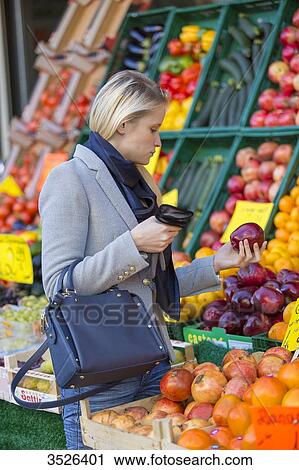 Pretty blonde woman buying healthy food on the market View Large Photo Image Stock Image - Pretty blonde woman buying healthy food on the market. Fotosearch